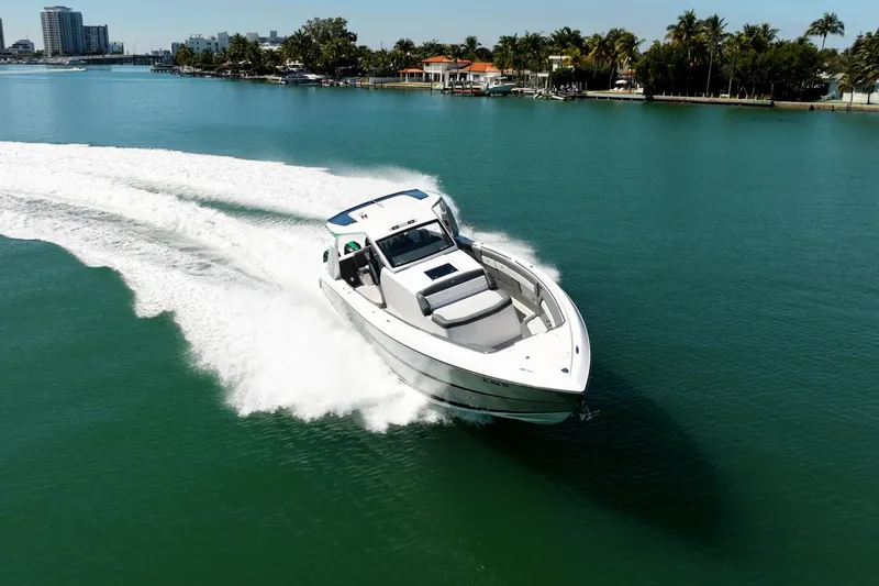 Slide: The Image of 2024 Cigarette 42' Auroris speedboat cruising on clear blue water. - 16