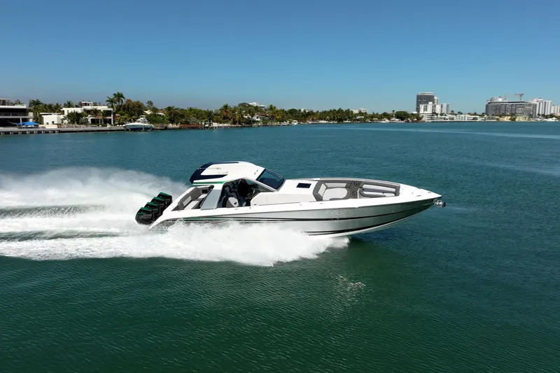 Slide: The Image of 2024 Cigarette 42' Auroris speedboat cruising on clear blue water. - 17