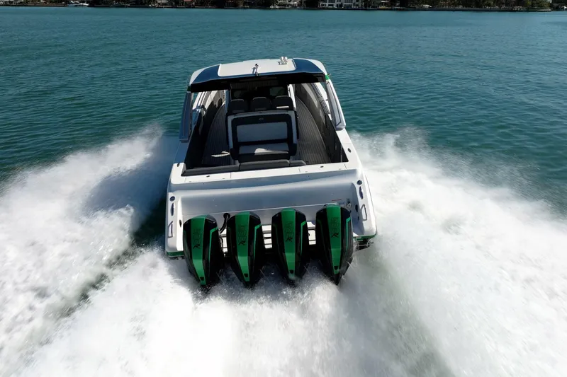 Slide: The Image of 2024 Cigarette 42' Auroris speedboat with four engines cruising on open water. - 18