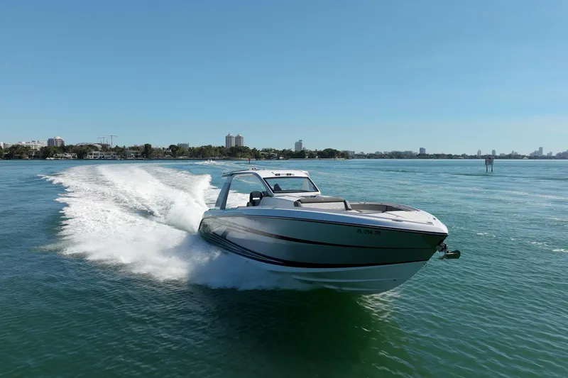 Slide: The Image of 2024 Cigarette 42' Auroris speedboat cruising on clear blue water. - 20