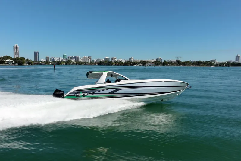 Slide: The Image of 2024 Cigarette 42' Auroris speedboat cruising on a sunny day near city skyline. - 21