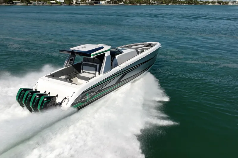 Slide: The Image of 2024 Cigarette 42' Auroris speedboat cruising on open water, showcasing sleek design and powerful engines. - 22