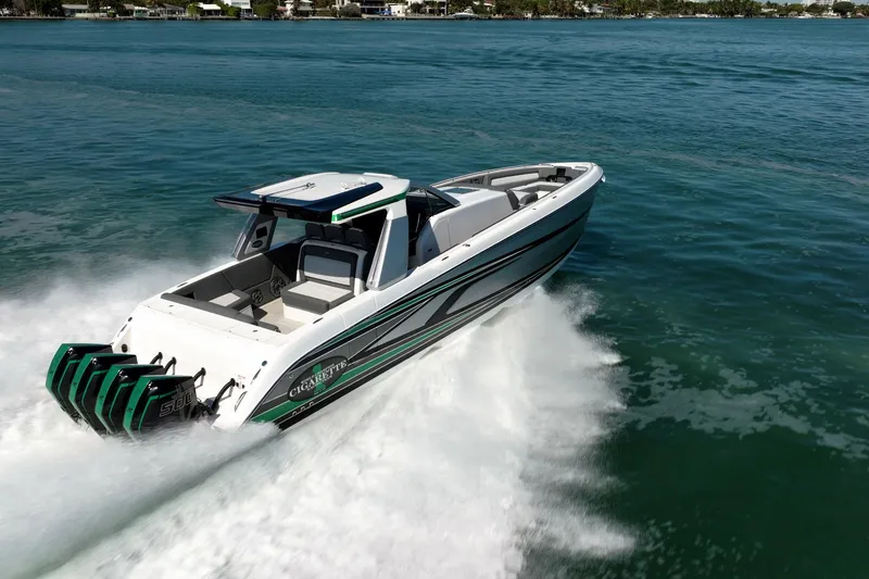 Slide: The Image of 2024 Cigarette 42' Auroris speedboat cruising on open water, showcasing sleek design and powerful engines. - 23