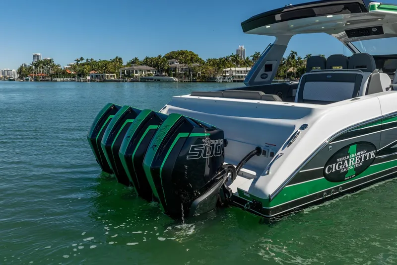 Slide: The Image of 2024 Cigarette 42' Auroris boat with powerful outboard engines on a sunny day. - 30