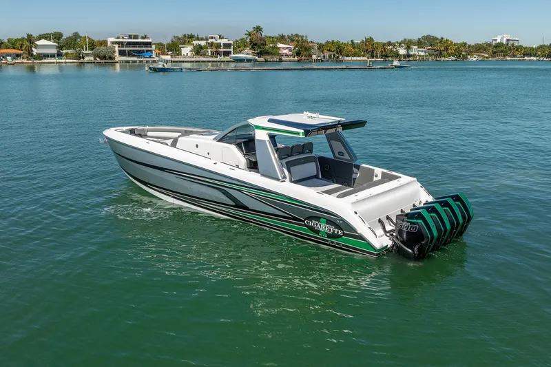 Slide: The Image of 2024 Cigarette 42' Auroris boat on calm water, showcasing sleek design and powerful engines. - 34