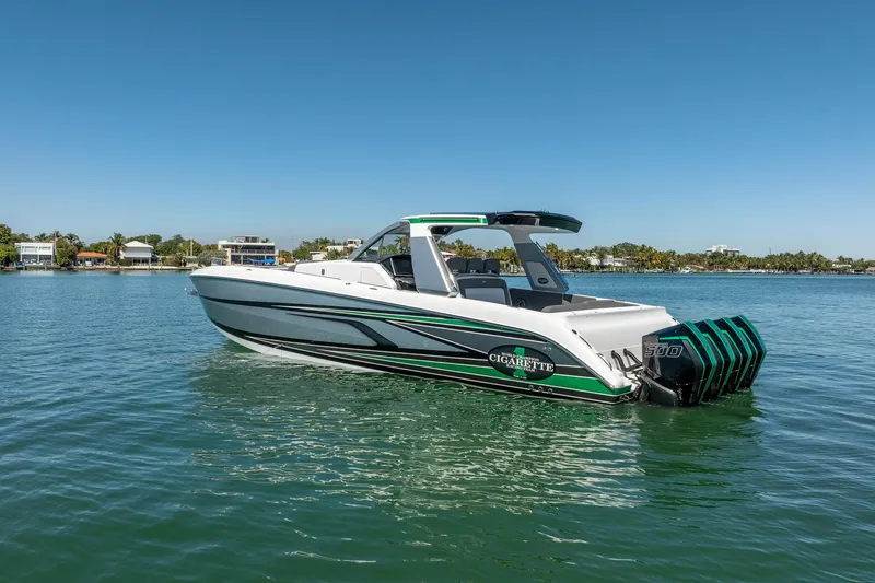 Slide: The Image of 2024 Cigarette 42' Auroris boat on calm water, showcasing sleek design and powerful engines. - 35