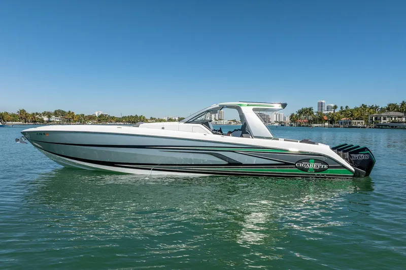 Slide: The Image of 2024 Cigarette 42' Auroris boat on calm water, sleek design, sunny day. - 36