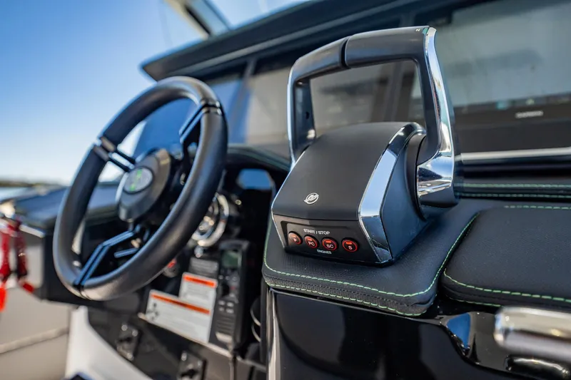 Slide: The Image of 2024 Cigarette 42' Auroris boat dashboard with steering wheel and throttle controls. - 48