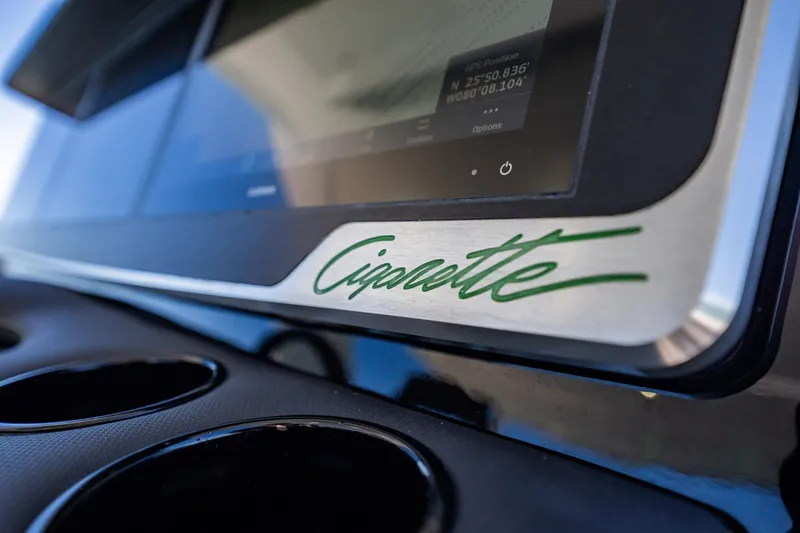 Slide: The Image of Close-up of 2024 Cigarette 42' Auroris dashboard with logo and display screen. - 49