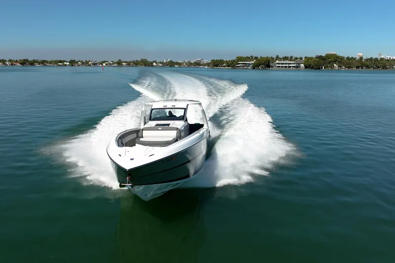 Slide: The Image of 2024 Cigarette 42' Auroris speedboat cruising on clear blue water. - 5