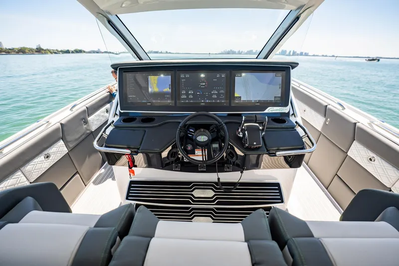 Slide: The Image of 2024 Cigarette 42' Auroris boat cockpit with advanced navigation screens and luxurious seating. - 50