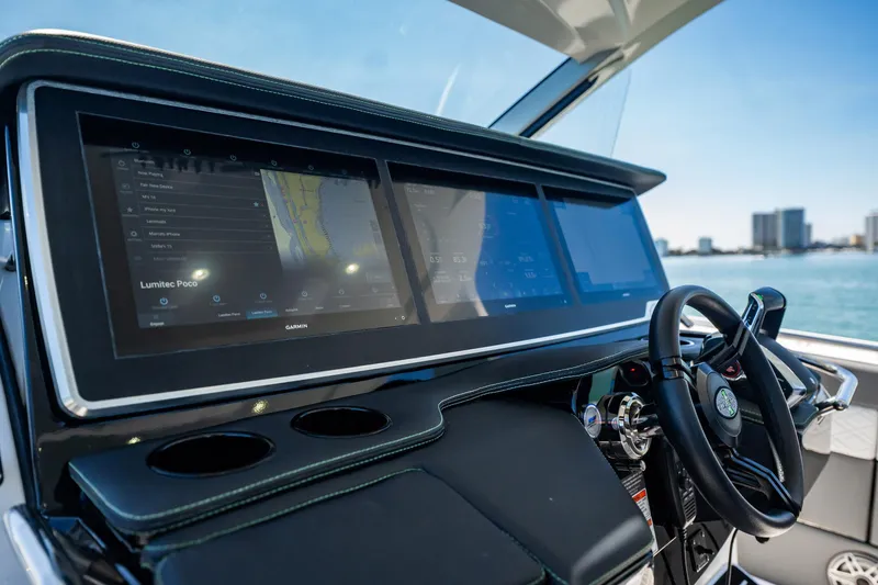 Slide: The Image of 2024 Cigarette 42' Auroris dashboard with advanced navigation screens and steering wheel. - 52
