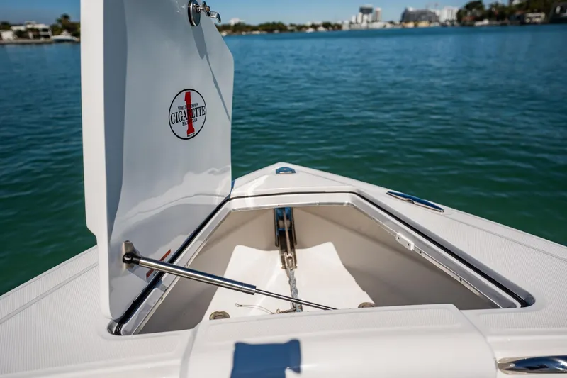 Slide: The Image of 2024 Cigarette 42' Auroris boat anchor compartment open on calm water. - 55