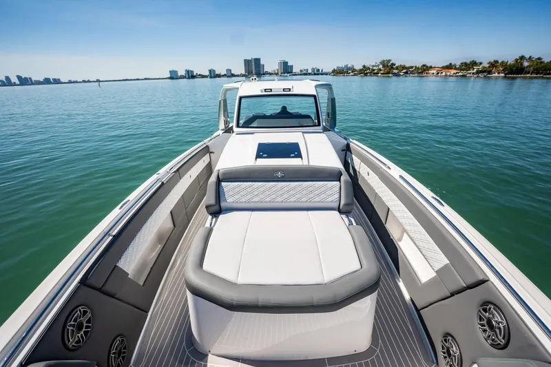 Slide: The Image of 2024 Cigarette 42' Auroris luxury boat interior with sleek seating and waterfront view. - 58