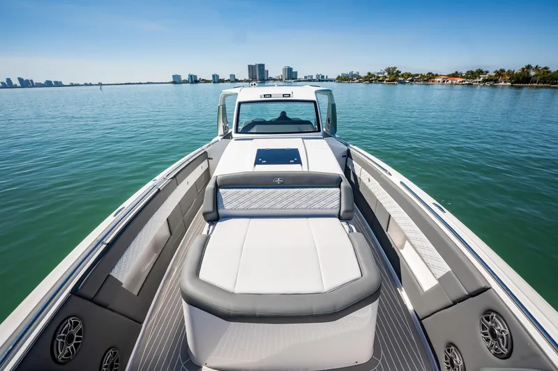 Slide: The Image of 2024 Cigarette 42' Auroris luxury boat on calm water with city skyline. - 59