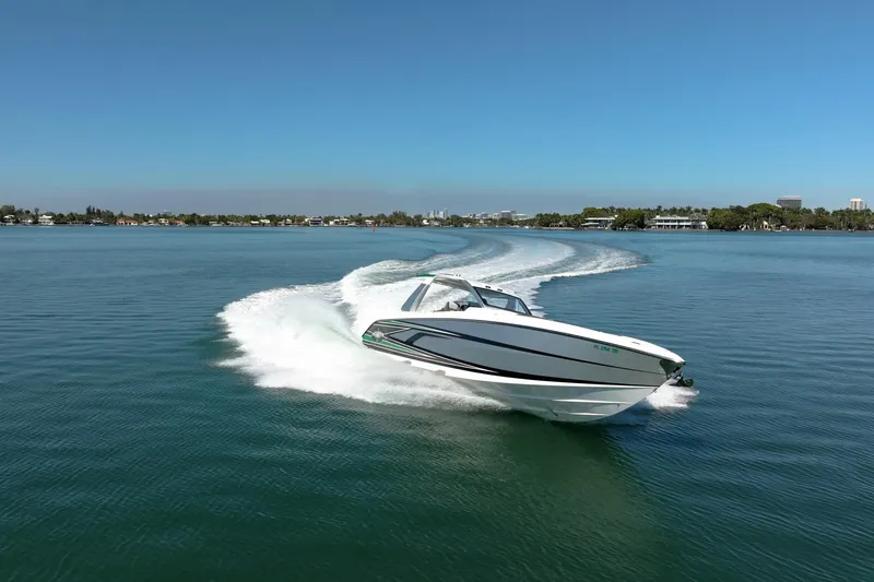 Slide: The Image of 2024 Cigarette 42' Auroris speedboat cruising on clear blue water. - 6