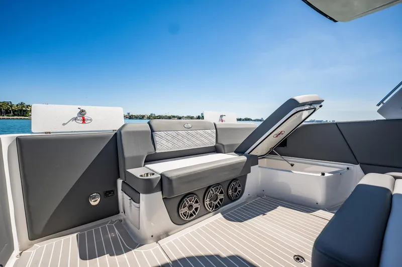 Slide: The Image of 2024 Cigarette 42' Auroris luxury boat interior with sleek seating and storage. - 62