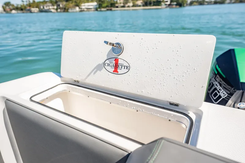Slide: The Image of 2024 Cigarette 42' Auroris boat storage compartment with water droplets, open on a sunny day. - 64