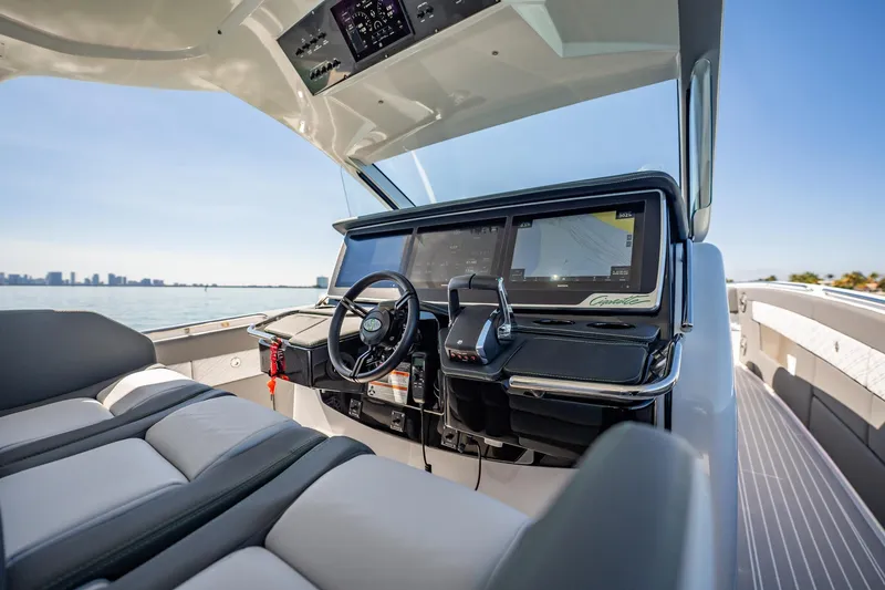Slide: The Image of 2024 Cigarette 42' Auroris luxury boat cockpit with advanced navigation system and sleek design. - 66