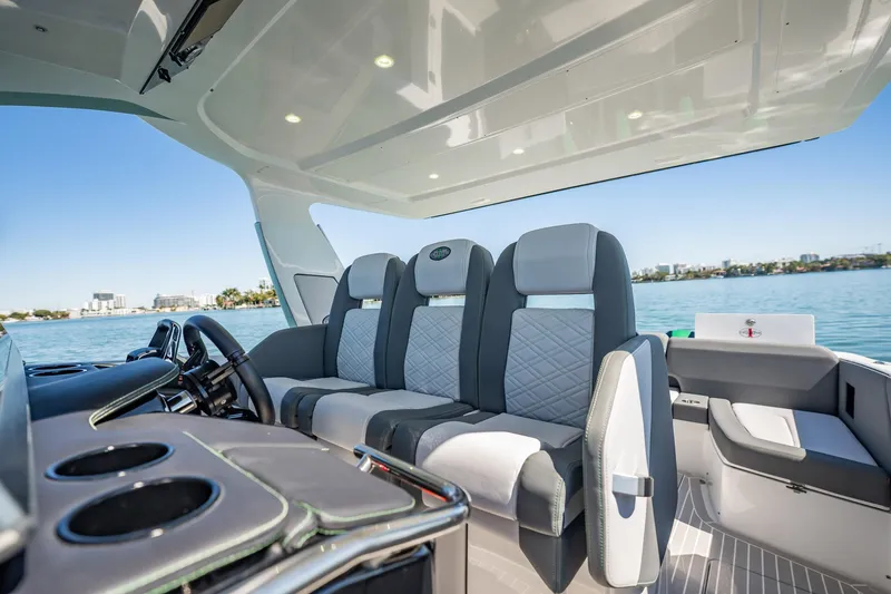 Slide: The Image of 2024 Cigarette 42' Auroris luxury boat interior with modern seating and ocean view. - 69