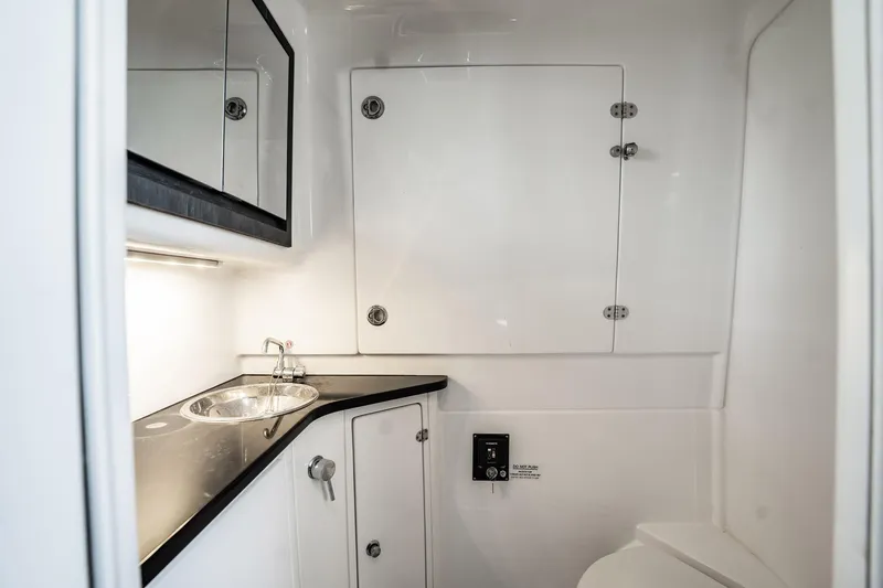 Slide: The Image of 2024 Cigarette 42' Auroris yacht bathroom with sleek sink and modern cabinetry. - 73