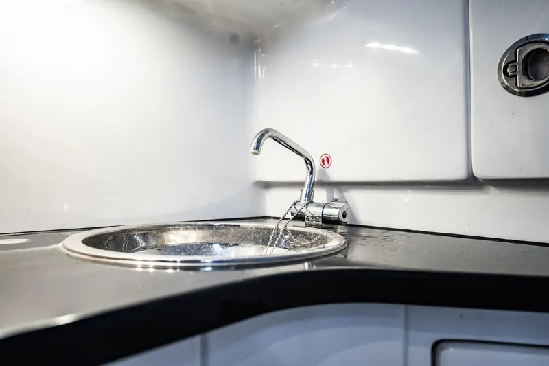 Slide: The Image of Modern sink in 2024 Cigarette 42' Auroris boat interior, featuring sleek design and chrome faucet. - 75