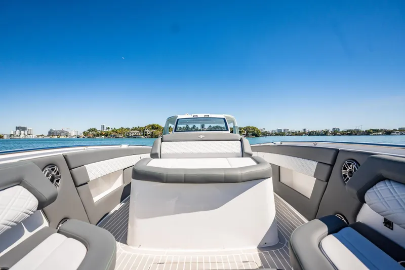 Slide: The Image of 2024 Cigarette 42' Auroris luxury boat interior with sleek seating and waterfront view. - 81