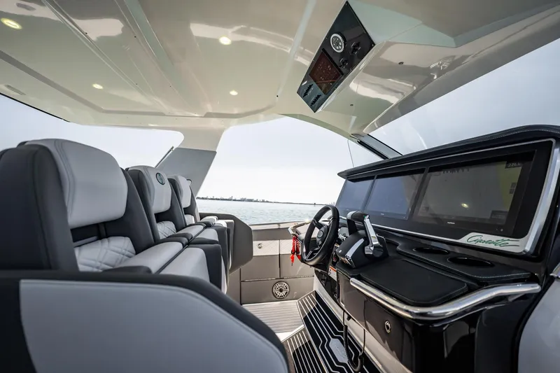 Slide: The Image of Interior of 2024 Cigarette 42' Auroris boat, featuring modern helm and luxurious seating. - 82