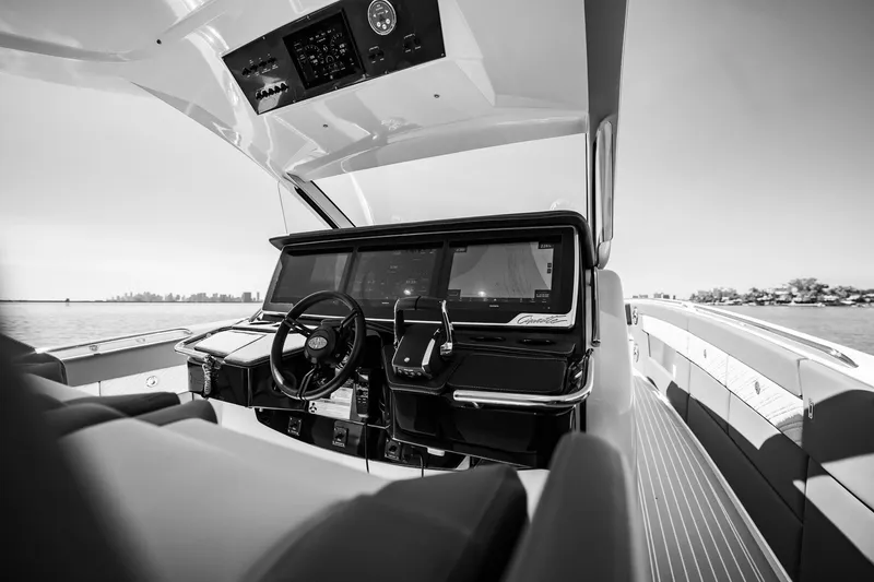 Slide: The Image of 2024 Cigarette 42' Auroris boat cockpit with modern controls, steering wheel, and ocean view. - 83