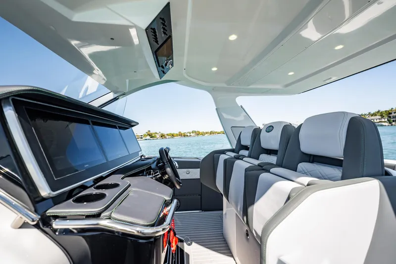 Slide: The Image of Interior of 2024 Cigarette 42' Auroris boat with luxurious seating and modern dashboard. - 85