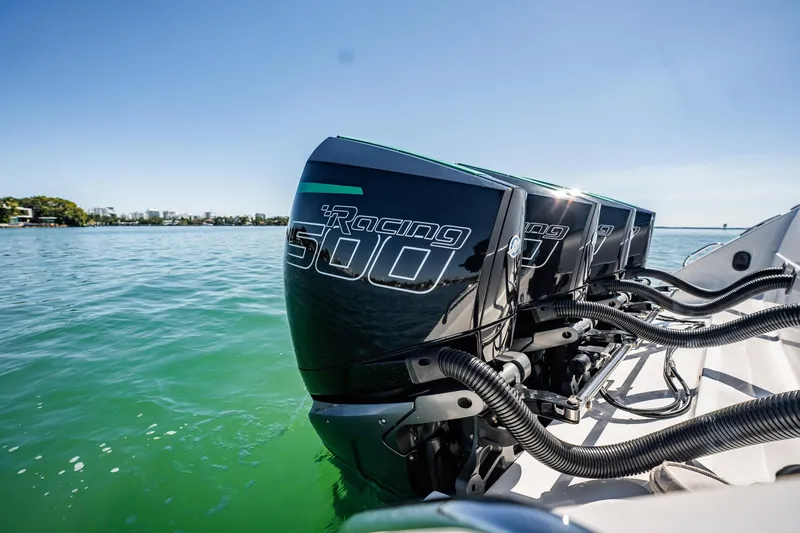 Slide: The Image of 2024 Cigarette 42' Auroris with powerful Racing 500 engines on clear water. - 88