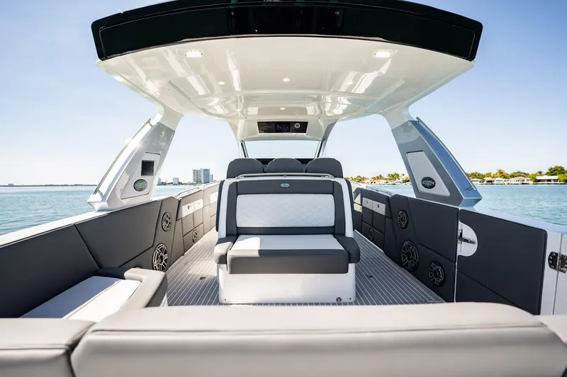 Slide: The Image of 2024 Cigarette 42' Auroris luxury boat interior with modern seating and sleek design on open water. - 90