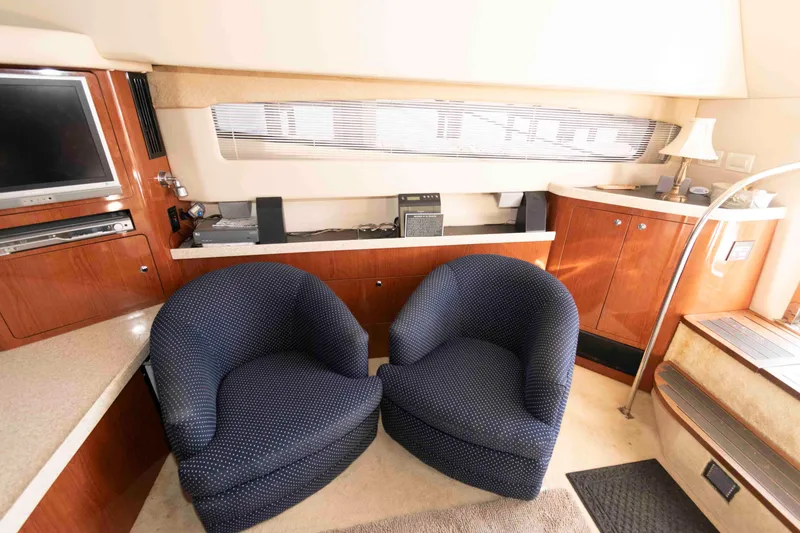 Slide: The Image of Interior of 2005 Regal Commodore 3880 yacht with cozy seating and entertainment area. - 11