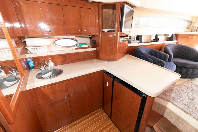 Slide: The Image of Luxurious 2005 Regal Commodore 3880 yacht interior with kitchenette and seating area. - 12