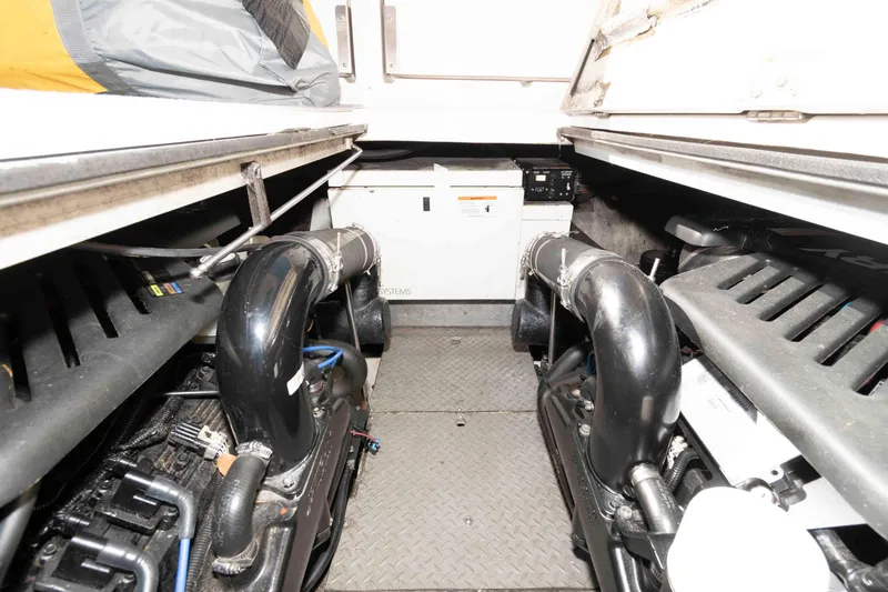 Slide: The Image of Engine room of a 2005 Regal Commodore 3880 boat, showcasing dual engines and equipment. - 16