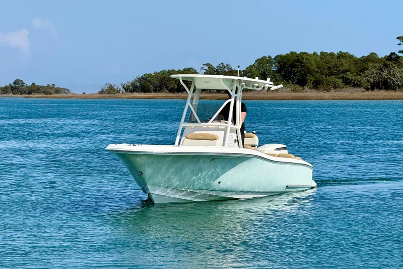 Slide: The Image of 2021 Pioneer 222 Islander boat cruising on serene blue waters. - 10