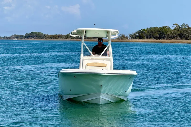 Slide: The Image of 2021 Pioneer 222 Islander boat cruising on clear blue water. - 11