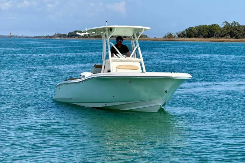 Slide: The Image of 2021 Pioneer 222 Islander boat cruising on clear blue water. - 12