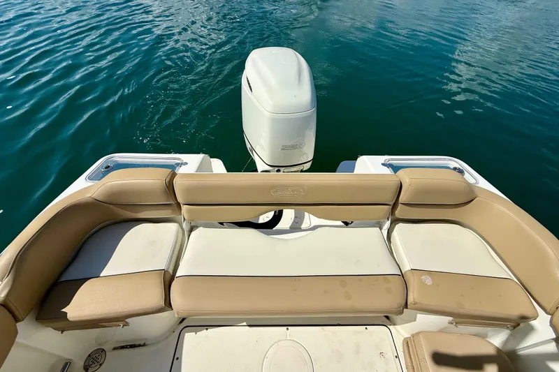 Slide: The Image of 2021 Pioneer 222 Islander boat with tan seating and outboard motor on water. - 14
