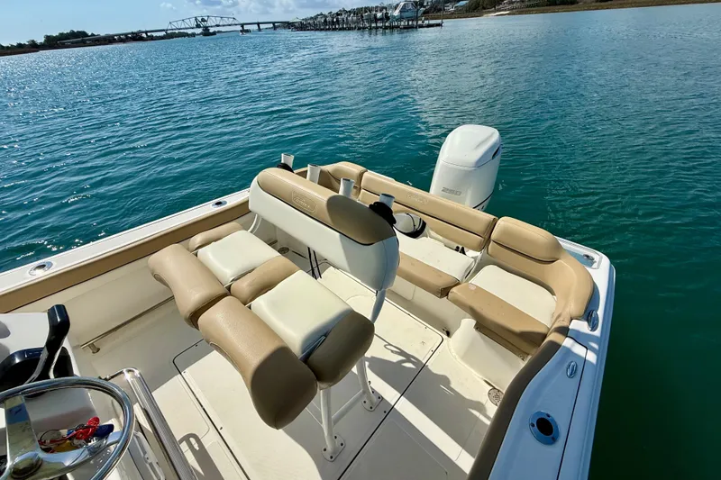 Slide: The Image of 2021 Pioneer 222 Islander boat with seating, on calm water near a bridge. - 17