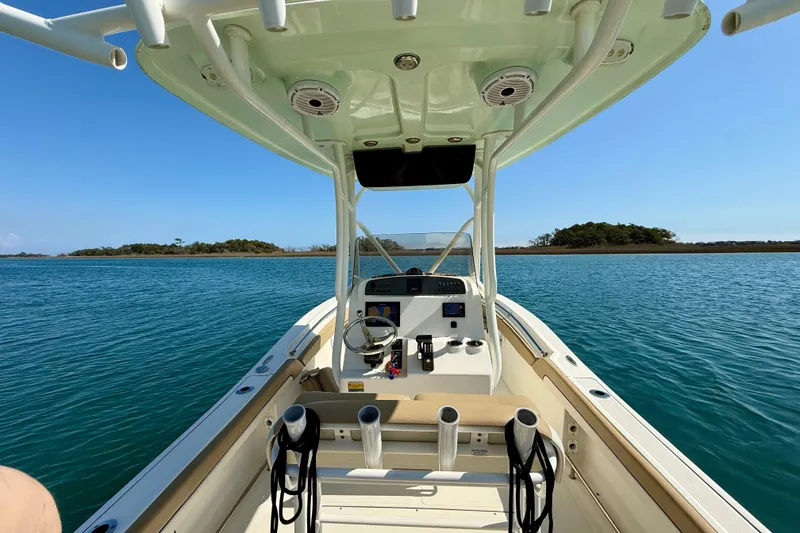 Slide: The Image of 2021 Pioneer 222 Islander boat on calm blue water with island view. - 21