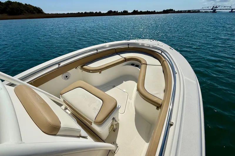 Slide: The Image of 2021 Pioneer 222 Islander boat with tan seating on calm water. - 29