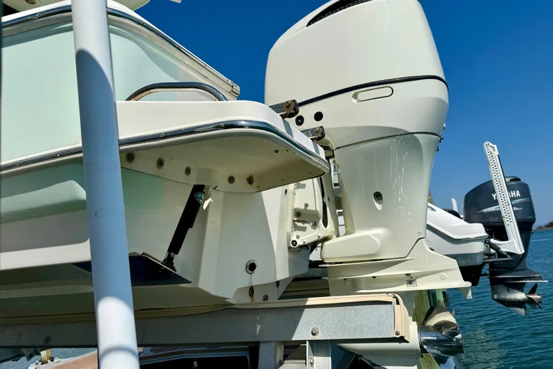 Slide: The Image of 2021 Pioneer 222 Islander boat with outboard motor, docked on a sunny day. - 34