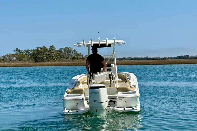 Slide: The Image of 2021 Pioneer 222 Islander boat cruising on clear blue water. - 5