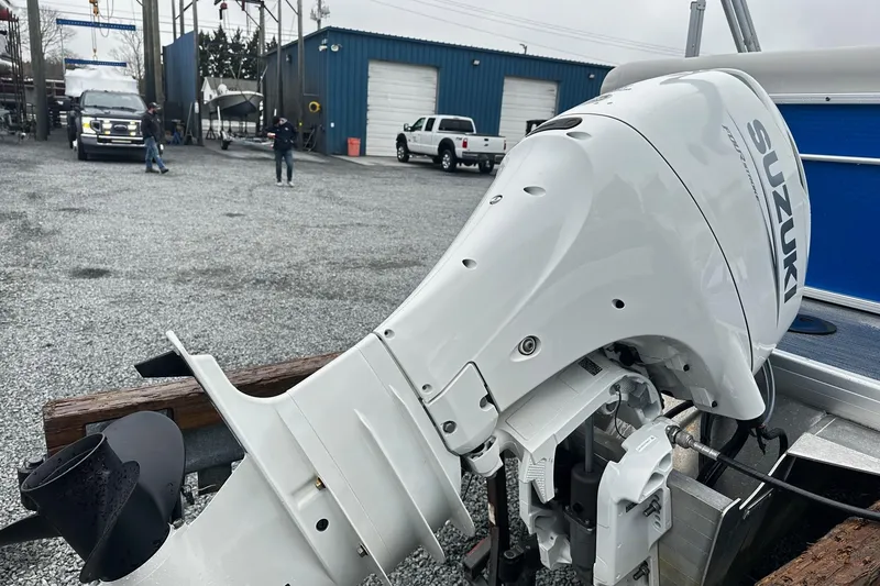 Slide: The Image of Suzuki outboard motor on 2021 Godfrey Sweetwater 2086CX pontoon boat at marina. - 11