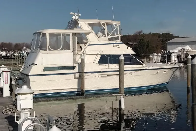 The Image of 1987 Hatteras 40 Motor Yacht docked at marina, featuring classic design and spacious cabin. - 0