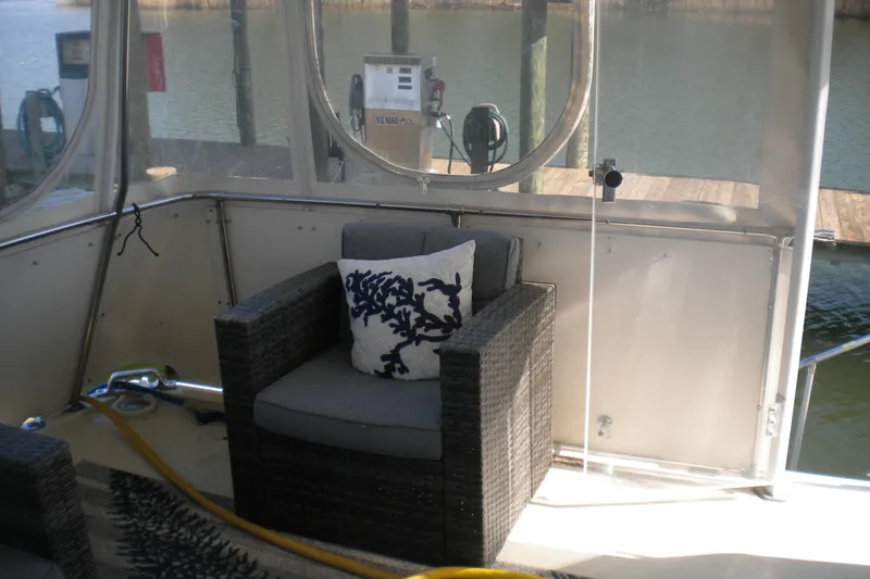 Slide: The Image of Cozy seating area on 1987 Hatteras 40 Motor Yacht with nautical-themed decor. - 16