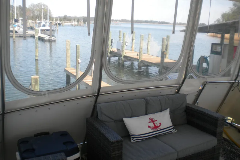 Slide: The Image of Interior view of 1987 Hatteras 40 Motor Yacht with marina backdrop. - 17