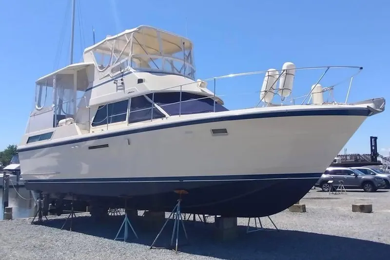 Slide: The Image of 1987 Hatteras 40 Motor Yacht on stands, side view, clear sky background. - 2