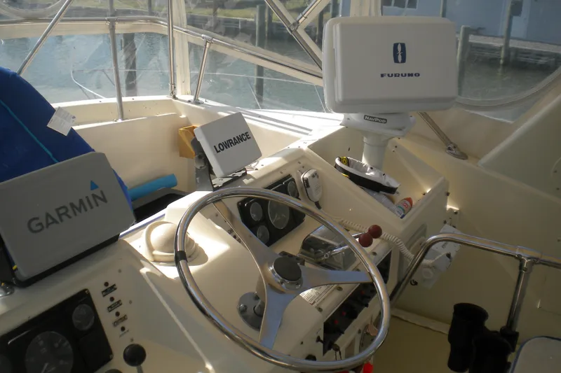 Slide: The Image of 1987 Hatteras 40 Motor Yacht helm with Garmin, Lowrance, and Furuno navigation equipment. - 20